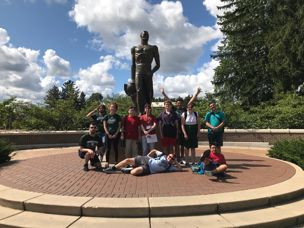 Bond group poses with sparty statue
