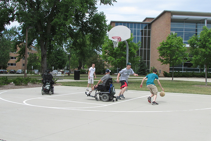 Project Venture students playing basketball, some using wheelchairs