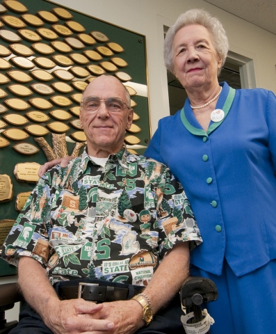 Harold and Phyllis Wochholz standing in front of the RCPD's Tree of Giving.