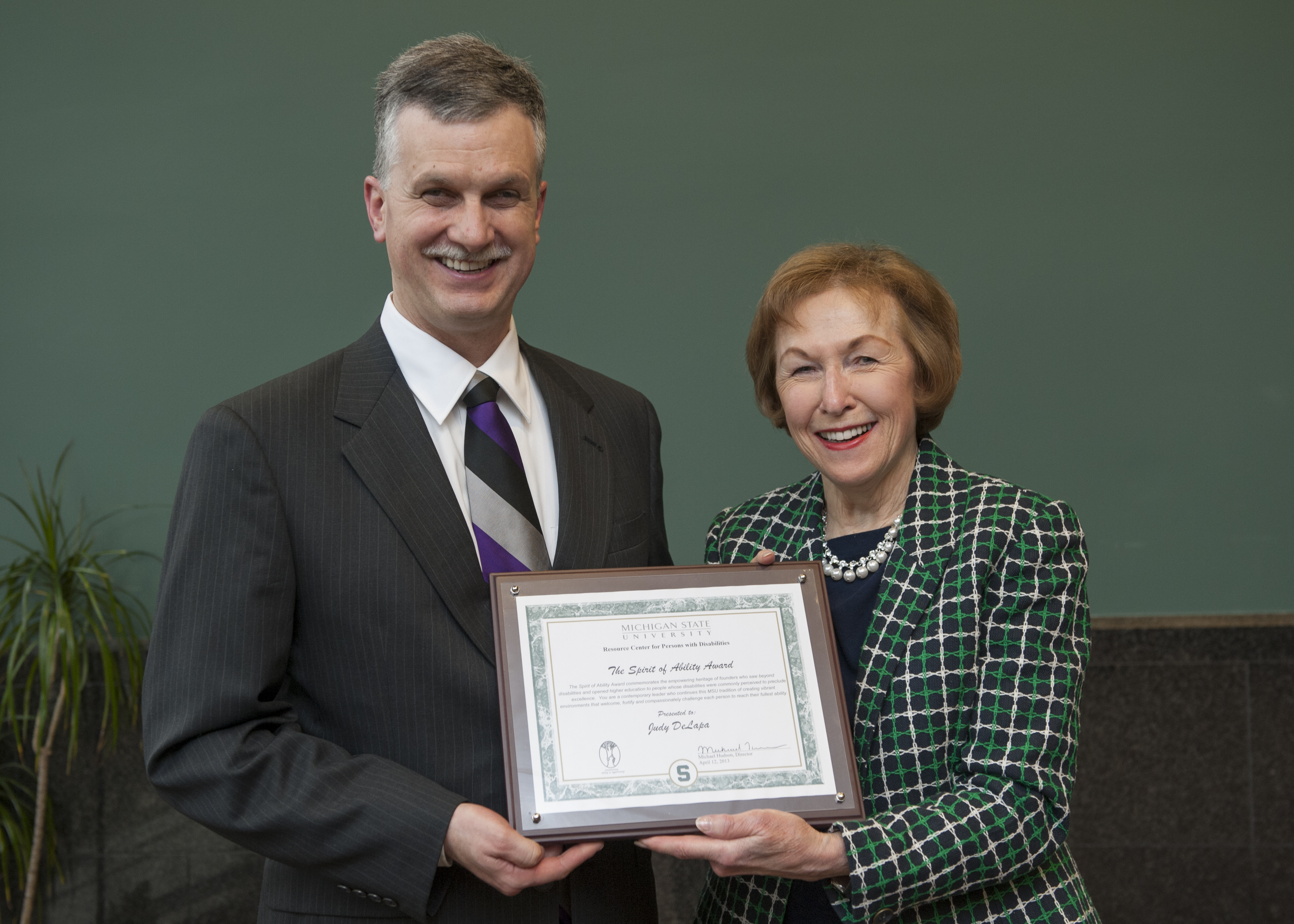 Judy DeLapa receiving Spirit of Ability Award from Michael Hudson in 2013