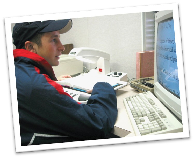 Student uses closed circut camera system to read classroom materials