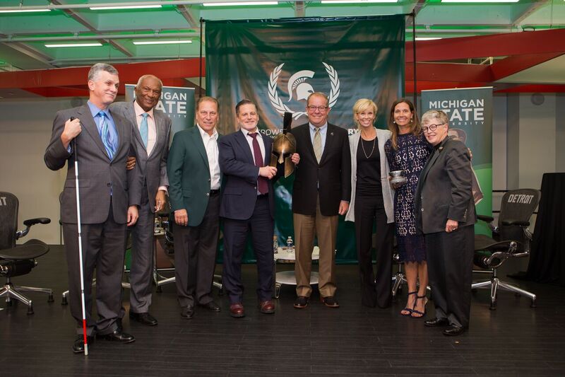 A group of MSU employees and trustees with Dan Gilbert