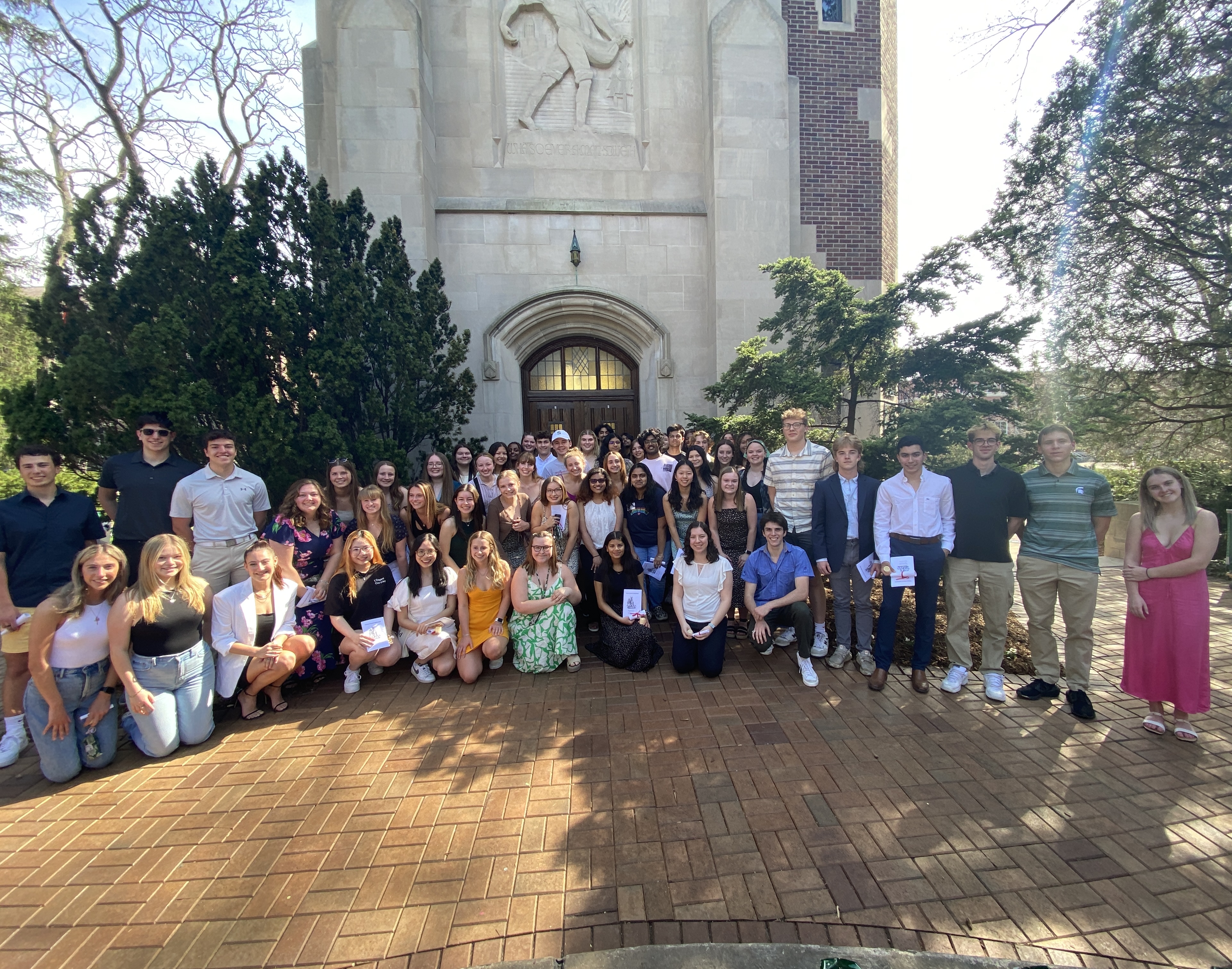 Group photo of the new 2023-2024 Tower Guard class in front of Beaumont Tower