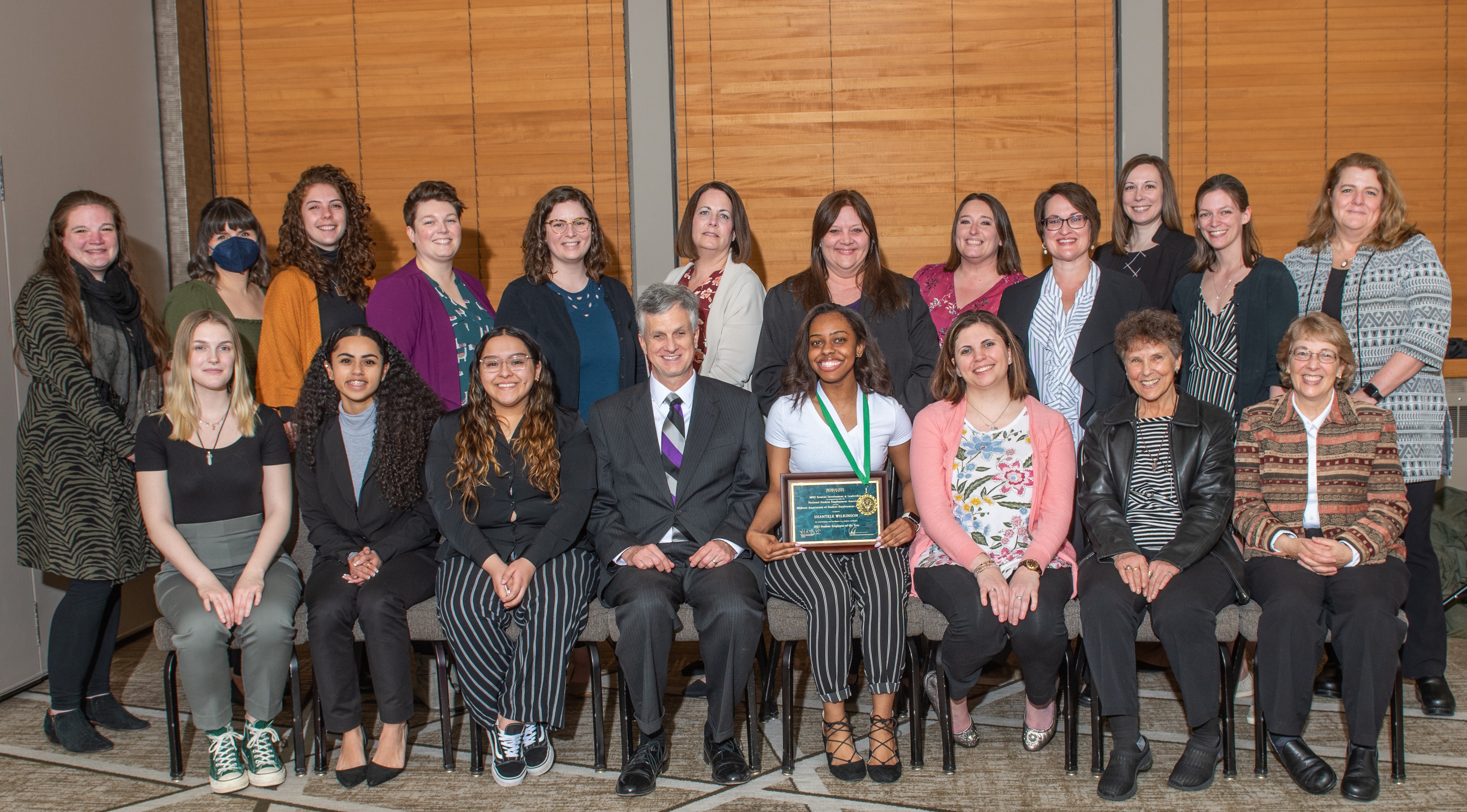 Staff Group Photo with Shantele Wilkinson holding Student Employee of the Year Award in the middle