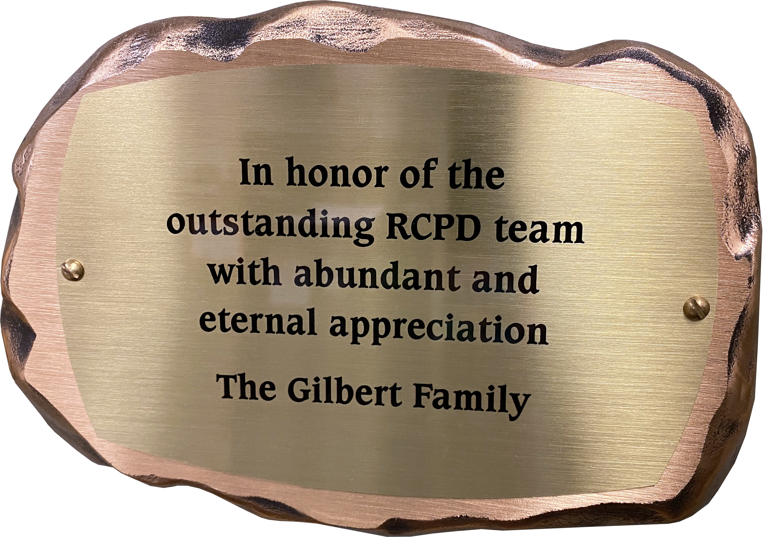 Inscribed bronze plaque in the shape of a rock with text on it reading: In honor of the outstanding RCPD team with abundant and eternal appreciation. The Gilbert Family