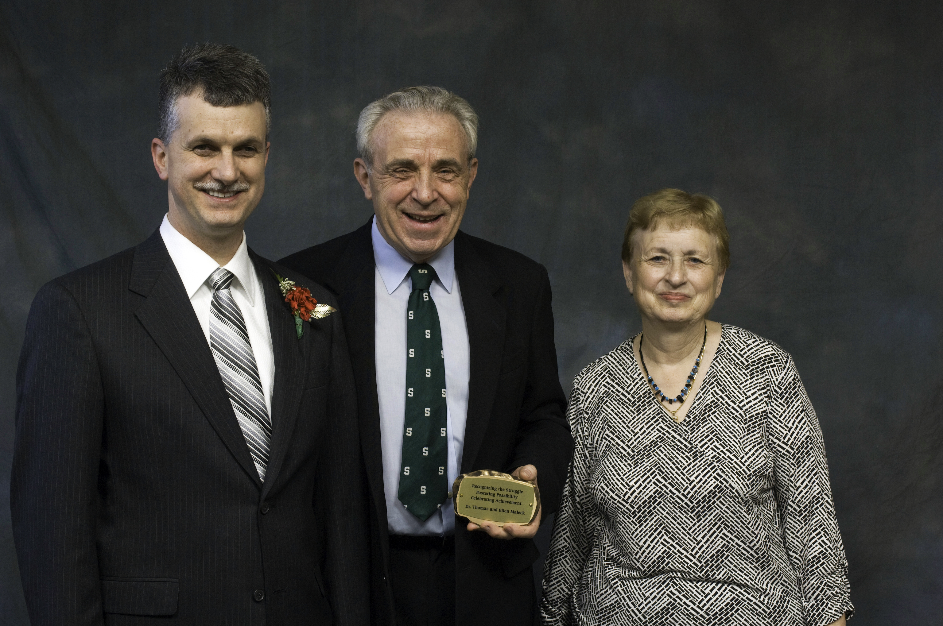 Tom and Ellen Maleck being presented their donor tree rock by Michael Hudson