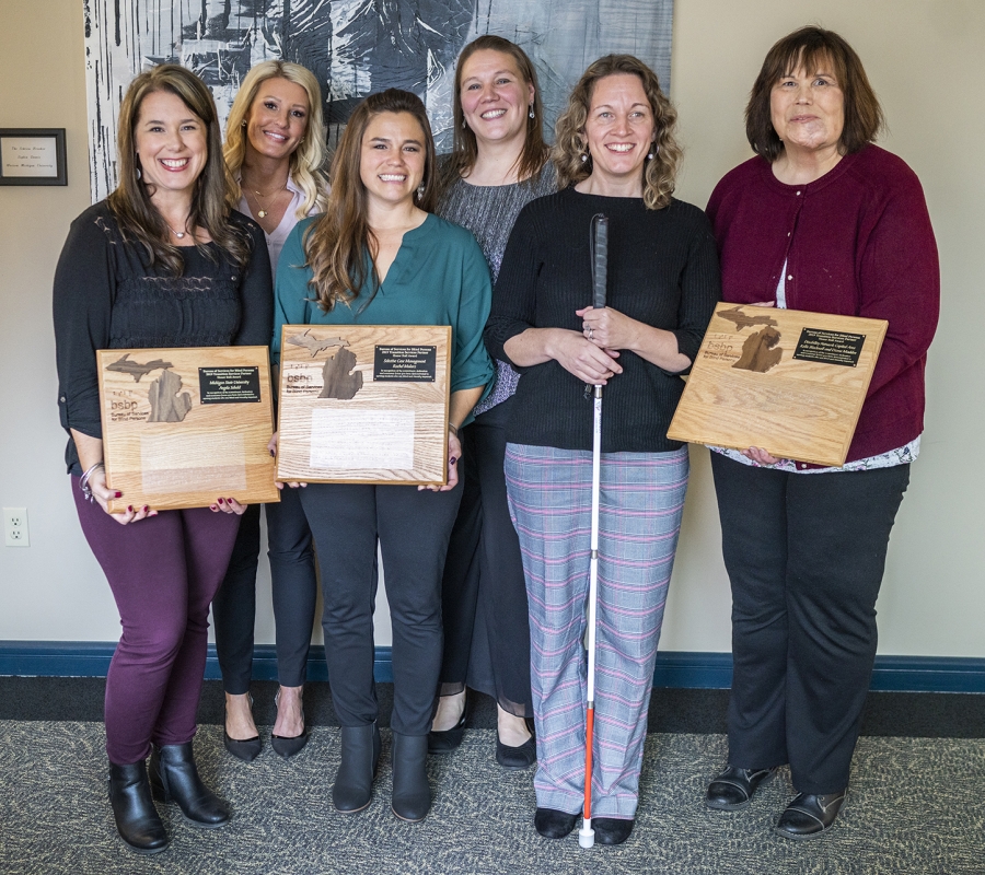 Photo of Angela Sebald and the TNT team posing with their awards