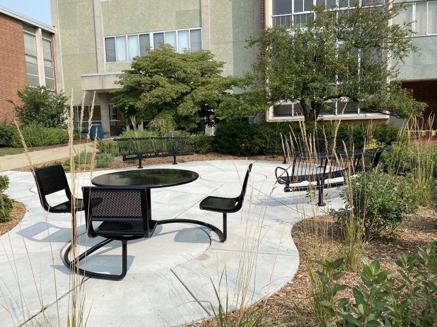 Photo of the Bessey Hall Seating Area, a round space with black metal benches and a black metal table with three chairs.