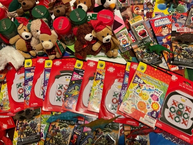 An assortment of toys, including teddy bears and coloring books
