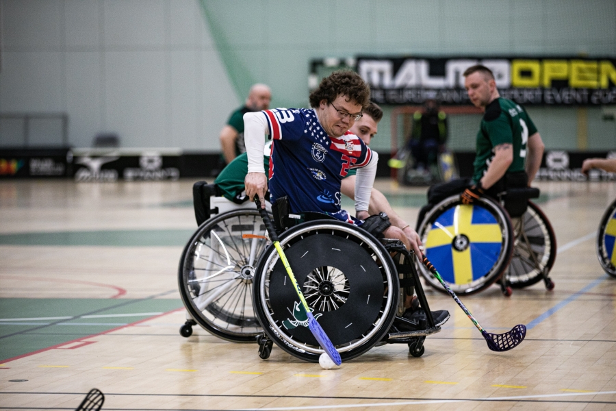 Action shot of teammate playing floorball