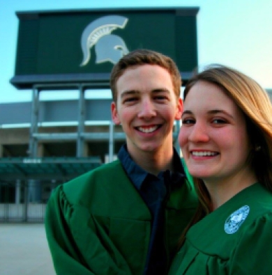 Liz and Cam's graduation photo outside Spartan Stadium