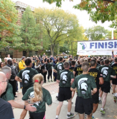 Army ROTC cadets running, approaching a "Finish" banner