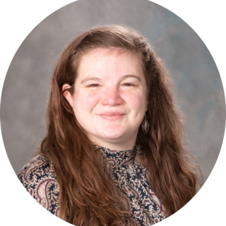 Photo of Tanya Adams, a light skinned woman with long, light brown hair smiling at the camera, wearing a patterned shirt.